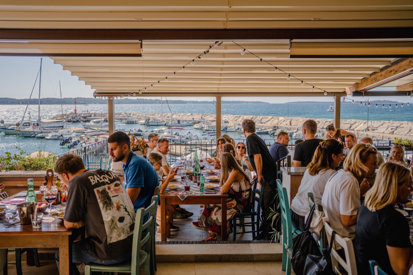 Group of guests at a long table on the terrace